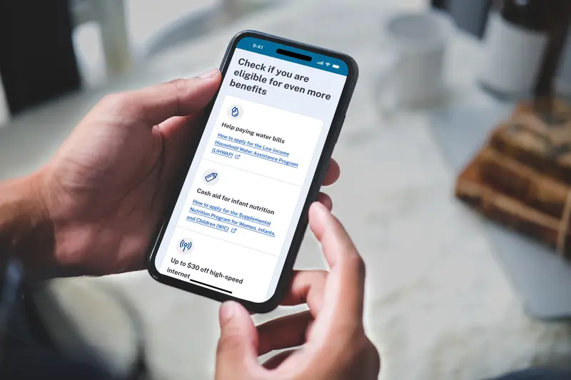 A person shopping for government benefits on a phone