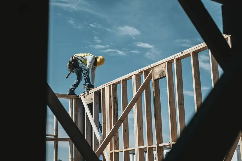 A construction worker building a house