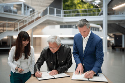 Governor Newsom and NVIDIA CEO Jensen Huang signing an agreement at NVIDIA offices