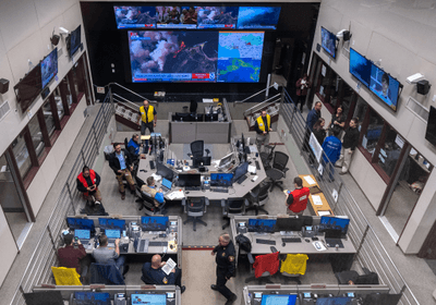 Situation room with desks and wall-sized monitors