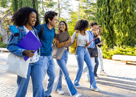 Smiling college students walking on campus