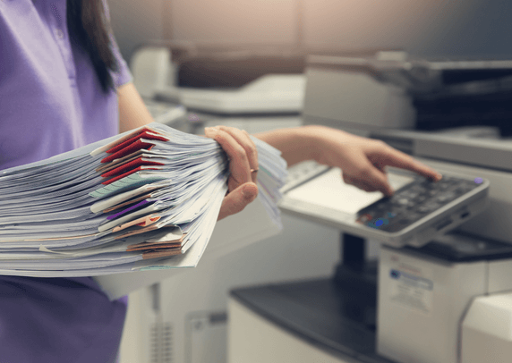 Person holding a pile of paper